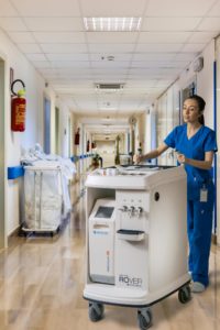 Nurse pushing dialysis cart
